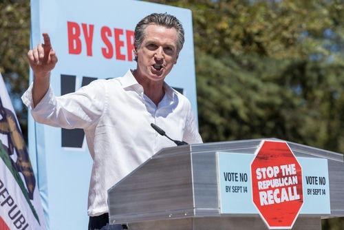 shutterstock2036606894jpg Gavin Newsom speaking at a podium, Stop the Republican Recall.
