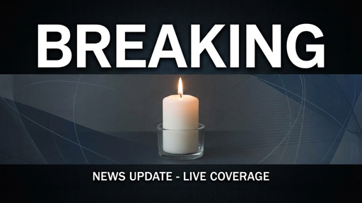 shutterstock_2756476889.jpg A lit candle with a breaking news banner above it