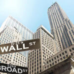 Insider Trading STORM: Trump’s Iran Secrets? Wall Street and Broad Street signs, skyscrapers in background.