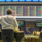 SpaceX IPO: $1.75 Trillion Dream or Risky Gamble? Person viewing stock market data on multiple screens.
