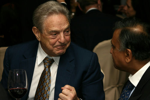 shutterstock39886369-1jpg Two men in suits conversing at an event.