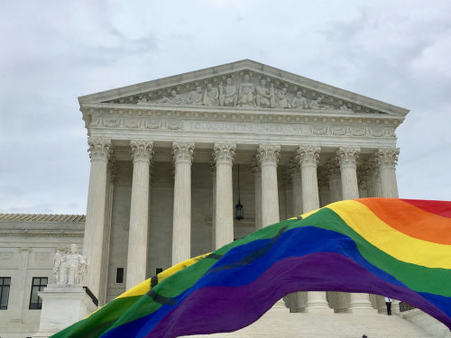shutterstock_1526443655.jpg Supreme Court building with rainbow flag in foreground.
