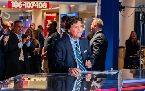 Miami,,Florida,-,November,17,,2022:,Fox,Nation,Patriot,Awards News anchor smiling in a television studio with an audience in the background