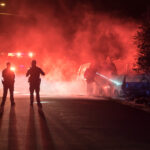 Car EXPLOSION Rocks Wall Street Icon! Police officers on a street surrounded by smoke and emergency lights
