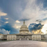 All-Night Brawl Hijacks Border Funding U.S. Capitol building under a dramatic sky at sunset.