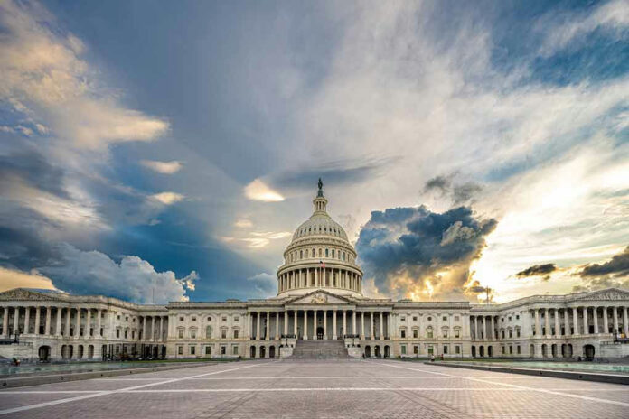 2110094846 U.S. Capitol building under a dramatic sky at sunset.