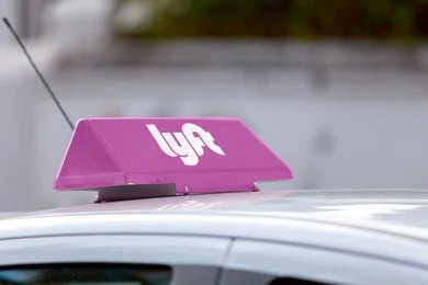 2171768513 rideshare car with pink roof sign