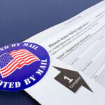 Trump’s Mail Voting Fight Escalates Mail-in ballot application with I Voted By Mail sticker.