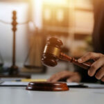 Track Meet Murder Ignites America Judge's hand striking a wooden gavel on a sound block