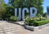 UCR sign sculpture by landscaped flower beds and trees