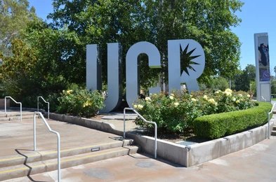 1535373845 UCR sign sculpture by landscaped flower beds and trees