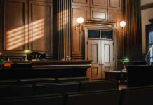Key Witness Gets Immunity In Kirk Case Empty courtroom with sunlight streaming through windows.