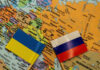 Ukrainian and Russian flags on map of Europe.