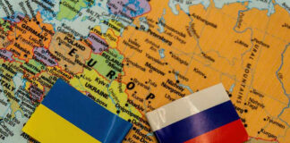 Ukrainian and Russian flags on map of Europe.