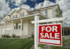 Why Seattle Families Are Selling Their Homes House with For Sale sign in front yard.