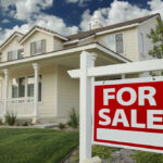 Why Seattle Families Are Selling Their Homes House with For Sale sign in front yard.