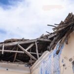 School Tragedy Sparks Negligence Probe People navigate rubble and collapsed concrete in a disaster scene
