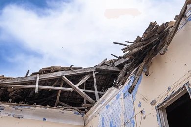 2469861775 People navigate rubble and collapsed concrete in a disaster scene