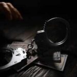 Livestream Murder Shocks Court Handcuffs on cash with a reaching hand in low light