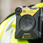 Body-worn camera attached to a high-visibility vest