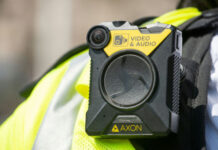 Accountability Theater At ICE Body-worn camera attached to a high-visibility vest