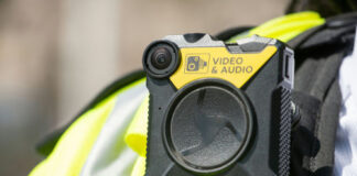 Body-worn camera attached to a high-visibility vest