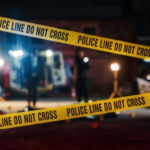 Deputy U.S. Marshal Killed Serving Warrant Yellow police tape at a nighttime crime scene.