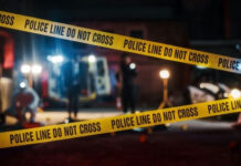 Deputy U.S. Marshal Killed Serving Warrant Yellow police tape at a nighttime crime scene.