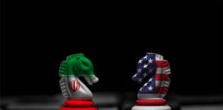 Chess knights with Iran and USA flags facing each other on a board