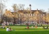 Campus Abortion Rollout Under Spotlight Students relaxing on a campus quad in front of a brick academic building