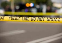 Police tape cordons off a street