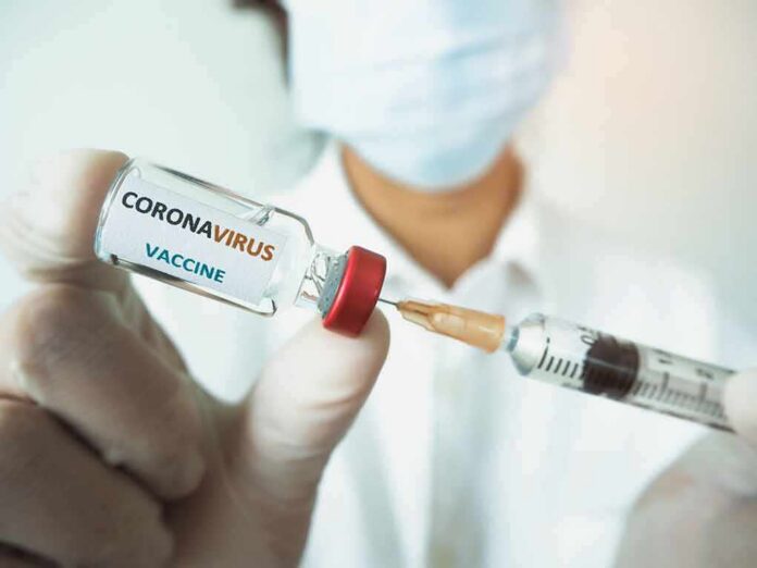 Healthcare worker holds a COVID-19 vaccine vial and syringe