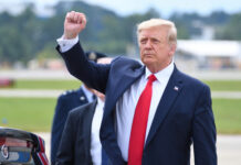 Alleged Iran Hit — Israel Sounds Alarm A political figure raising a fist in a gesture of confidence during an outdoor event