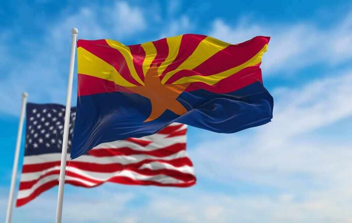 shutterstock_2282543749 Arizona state flag waving with U.S. flags in background