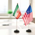 Inside The New U.S.-Iran Agreement Mini flags of Iran and the United States on a conference table