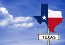 Houston Showdown Exposes Raw Distrust Texas state-shaped sign with flag colors against a blue sky