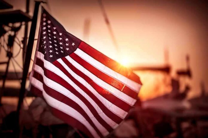 shutterstock_683517748 American flag waving at sunset