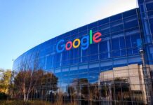 Google's headquarters with reflective glass windows and logo.