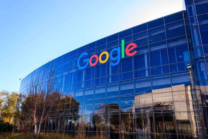 Google's headquarters with reflective glass windows and logo.