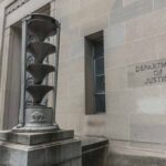 Department of Justice building entrance with statues.