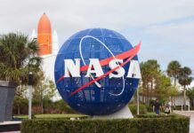 NASA globe sculpture with rocket in background.