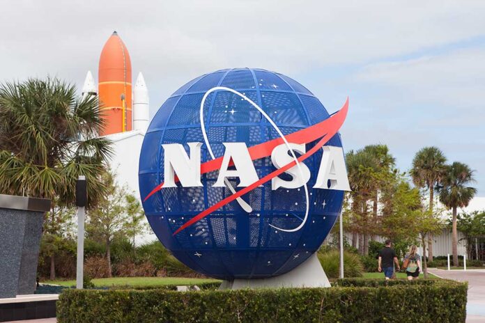 NASA globe sculpture with rocket in background.