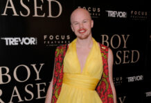 Person in yellow dress at Boy Erased event.