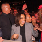 Kamala Harris smiling in a crowd at an event.