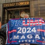 People holding Trump 2024 MAGA banner outside Trump Tower.