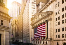 New York Stock Exchange building with American flag.